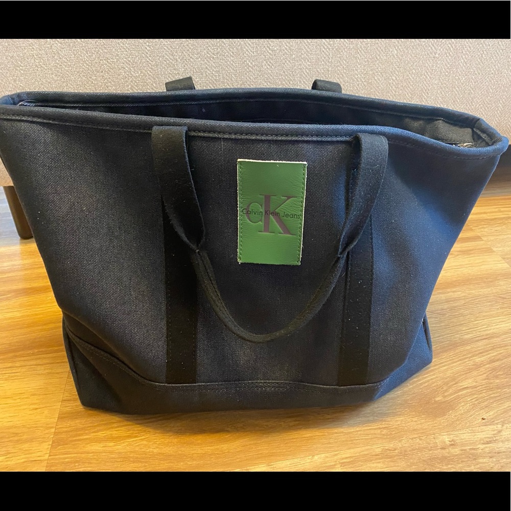 Calvin Klein Jeans large weekender bag. Denim fabric with green patch detail.